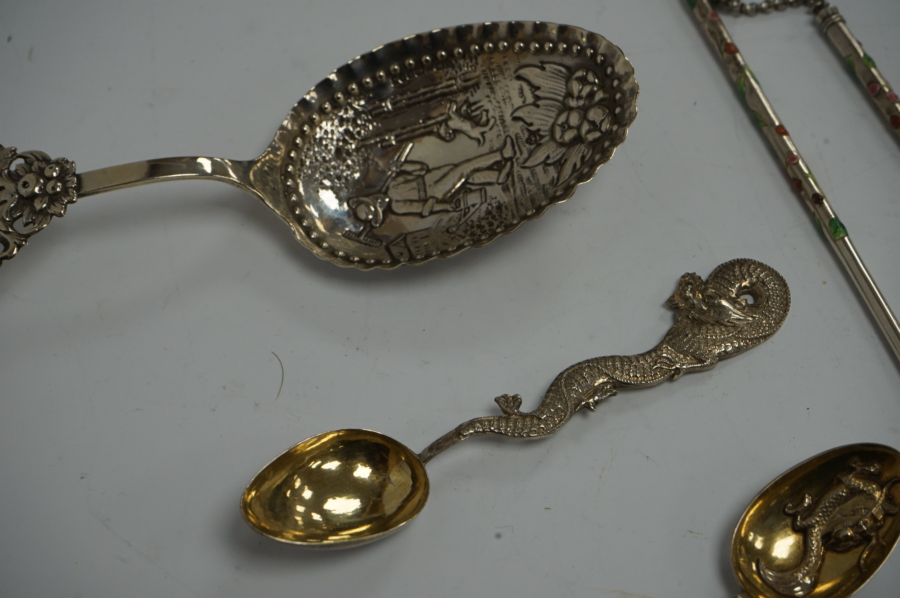 An early 19th century continental silver spoons, with embossed bowl and pieced terminal, import marks for Elly Isaac Miller, London, 1901, 17cm, together with two Chinese white metal spoons, one by Wang Hing and a pair o